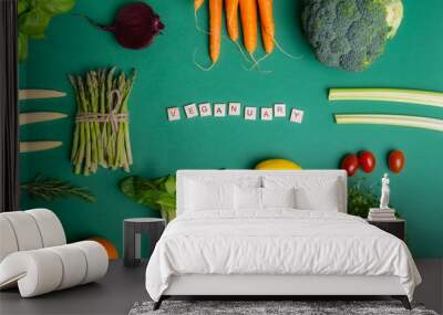 Top view set of healthy raw vegetables on the green background with Veganuary message on wooden blocks. Vegetarian and vegan diet. Veganism concept. Sustainable lifestyle, good, real plant-based foods Wall mural