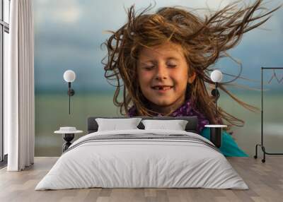 Girl with developing hair in the wind Wall mural