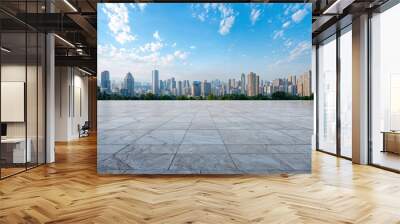 Expansive marble floor with modern city skyline backdrop under clear blue sky, dominated by sleek skyscrapers in bustling business district, inviting contemplation and tranquility Wall mural