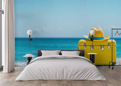 Yellow suitcase with a straw hat on a beautiful tropical beach concept of summer vacation and travel. High quality photo Wall mural