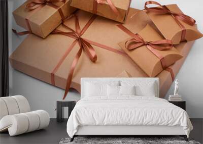 A Christmas gift. Box with brown satin ribbon on a white background. Wall mural