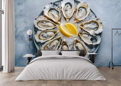 A plate of fresh oysters served on ice with lemon wedges Wall mural