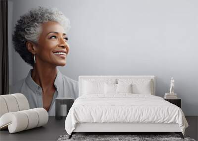 Beautiful african american senior woman portrait isolated on light grey background Wall mural