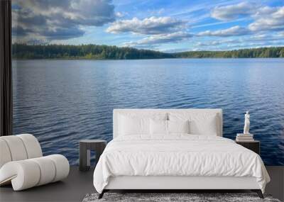 beautiful blue lake view, blue sky with white clouds reflections on the lake surface Wall mural