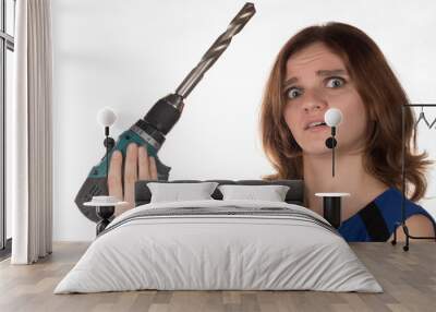 Girl with a working tool screwdriver laughing on a white backgro Wall mural