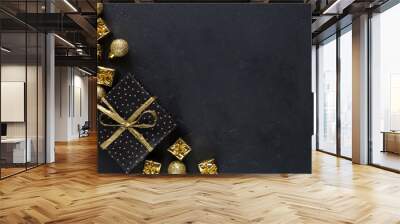 Black christmas background with gifts and golden decor. Christmas backgroun Wall mural