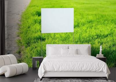 Blank yard sign on green grass on sunny day. Yard sign mockup in the park near the walking path Wall mural