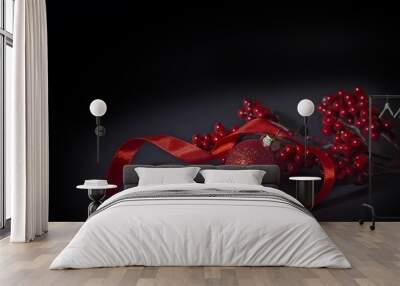 New Year decoration with a red ball, black background Wall mural