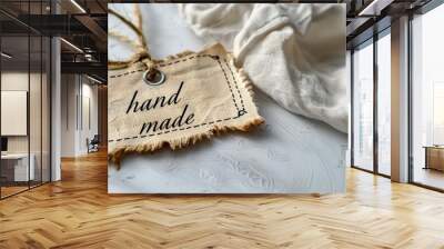 Close-up of a handmade tag on a textured fabric with a rope on a white background. Banner with copy space Wall mural