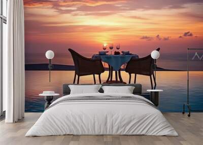 Dining table set for two with wine glasses at sunset by an infinity pool overlooking the ocean. Romantic Sunset Dinner by Infinity Pool Wall mural