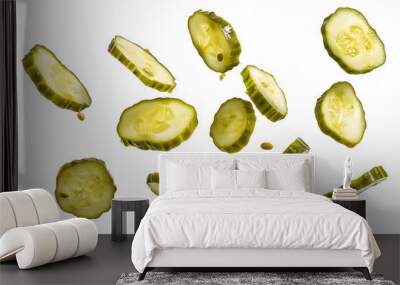 Falling pickled cucumber slices isolated on white background Wall mural