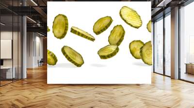 Falling pickled cucumber slices isolated on white background Wall mural