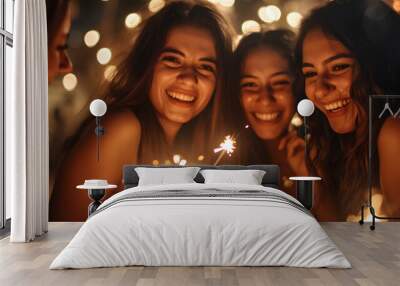 Group of girls friends having fun for celebration and holding a burn sparkler lights Wall mural