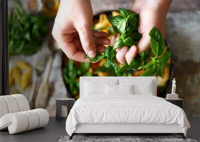 Hands of a chef with basil for cooking Italian pasta. Cooking one pan pasta. Wall mural