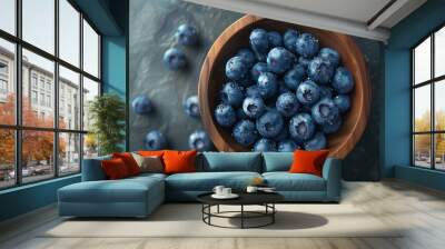 Juicy fresh blueberries in a wooden bowl, covered with water droplets, creating a refreshing and natural look. The berries have a deep blue color and smooth texture, making the image realistic Wall mural