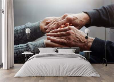 Closeup of hands of old man and a young female hands. Senior man, with caregiver indoors. Concept of health caring for elderly old people, disabled. Wall mural