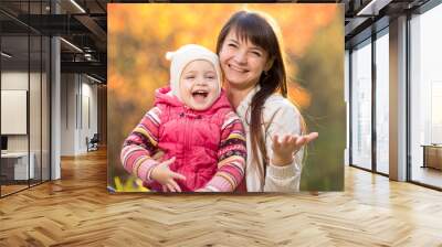 beautiful mother with kid girl outdoors in fall Wall mural