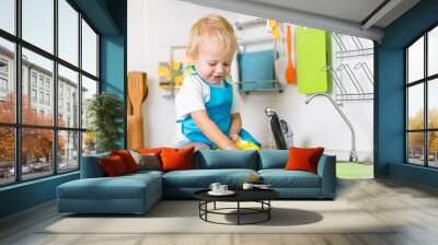 child washing up in a domestic kitchen Wall mural