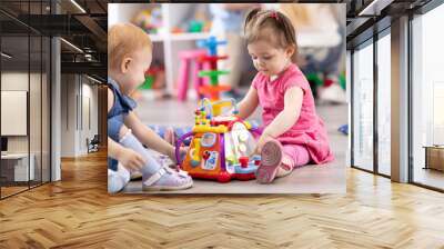 Children play together in kindergarten or day care centre Wall mural