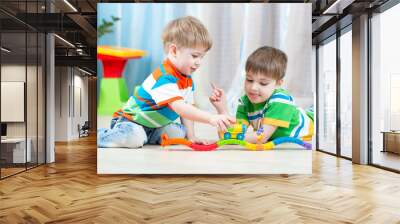 children playing rail road toy in nursery Wall mural