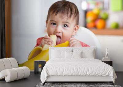 Cute baby eating banana Wall mural