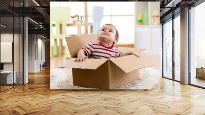 cute little baby infant boy sitting inside cardboard box, moving out concept Wall mural