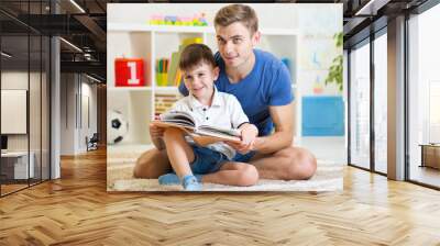 cute smiling kid reading book in children room Wall mural