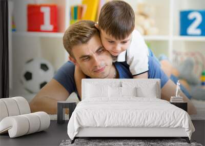 father and son kid play with tablet computer indoors Wall mural