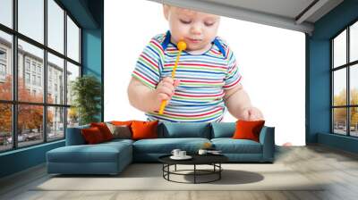 Funny child playing  with musical toys. Isolated on white backgr Wall mural