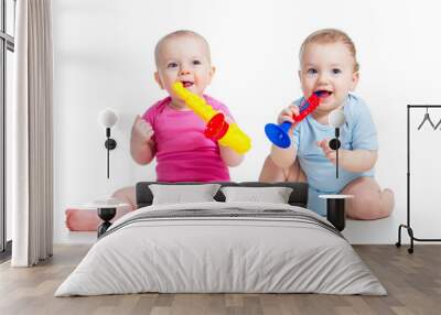 Funny children girl and boy playing with musical toy. Isolated o Wall mural