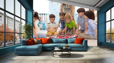 Group of kids learning time with clock toy in kindergarten Wall mural