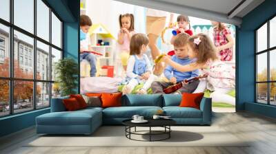 Group of kids playing with musical instruments in daycare Wall mural