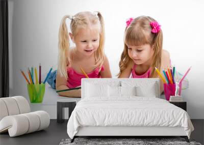 two girls drawing with color pencils together over white backgro Wall mural