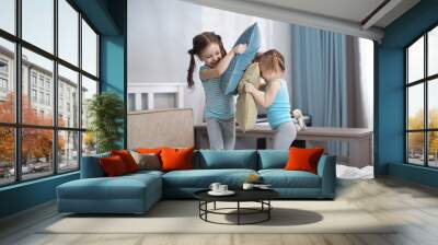 Two kids girls playing with pillows at home Wall mural