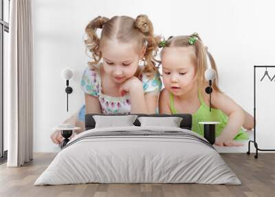 two sisters reading a book together Wall mural