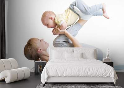 young mother does fitness exercises together with baby boy isolated Wall mural