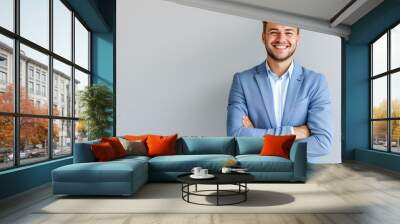 Portrait of Handsome smiling man in suit isolated on light background Wall mural