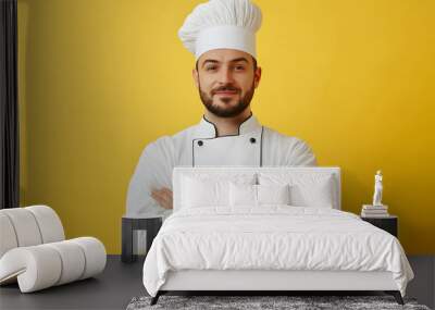 Portrait of Young handsome chef in white outfit with crossed arms looking at camera Wall mural