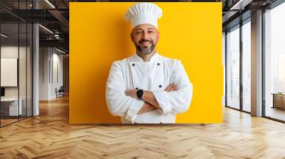 Portrait of Young handsome chef in white outfit with crossed arms looking at camera Wall mural