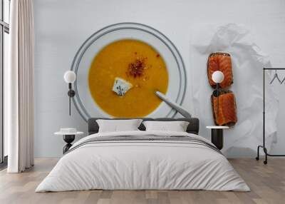 Pumpkin soup with cheese and two sandwiches with red fish on the table. Wall mural