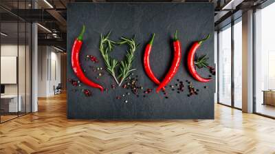 red chili pepper on a dark background with rosemary, written love Wall mural