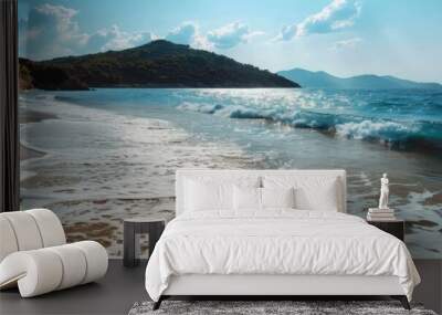 Sandy beach with gentle waves and hills in the background. Coastal landscape for travel Wall mural