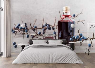 Homemade sloe berry alcohol drink, berries liqueur. Selective focus. Copy space. Wall mural