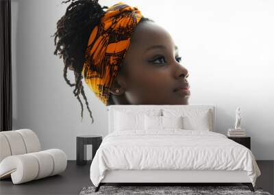 Side view portrait of a joyful African woman with glowing dark skin, captured in a close-up against a plain white background Wall mural