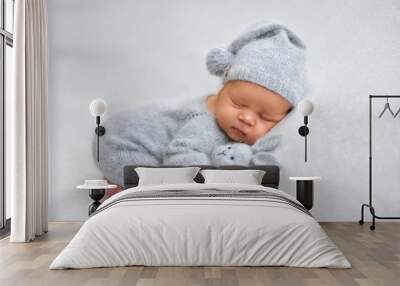 Sleeping newborn boy in the first days of life on white background Wall mural