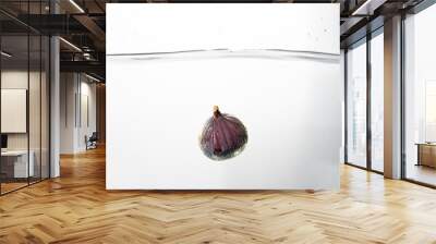 Fresh figs falling deeply into clear water isolated on a white background. Healthy food diet freshness concept. Copy space.. Wall mural