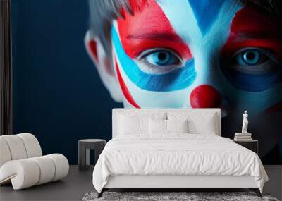 Young Boy with Colorful Circus Clown Face Paint and Expressive Eyes Wall mural