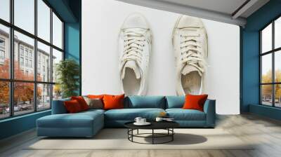 Top view pair of white used old dirty basic sneakers isolated on white background Wall mural