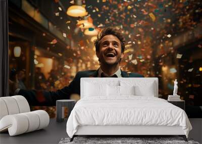 Happy man laughing among confetti. Wall mural