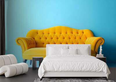 Yellow sofa, isolated on blue background Wall mural